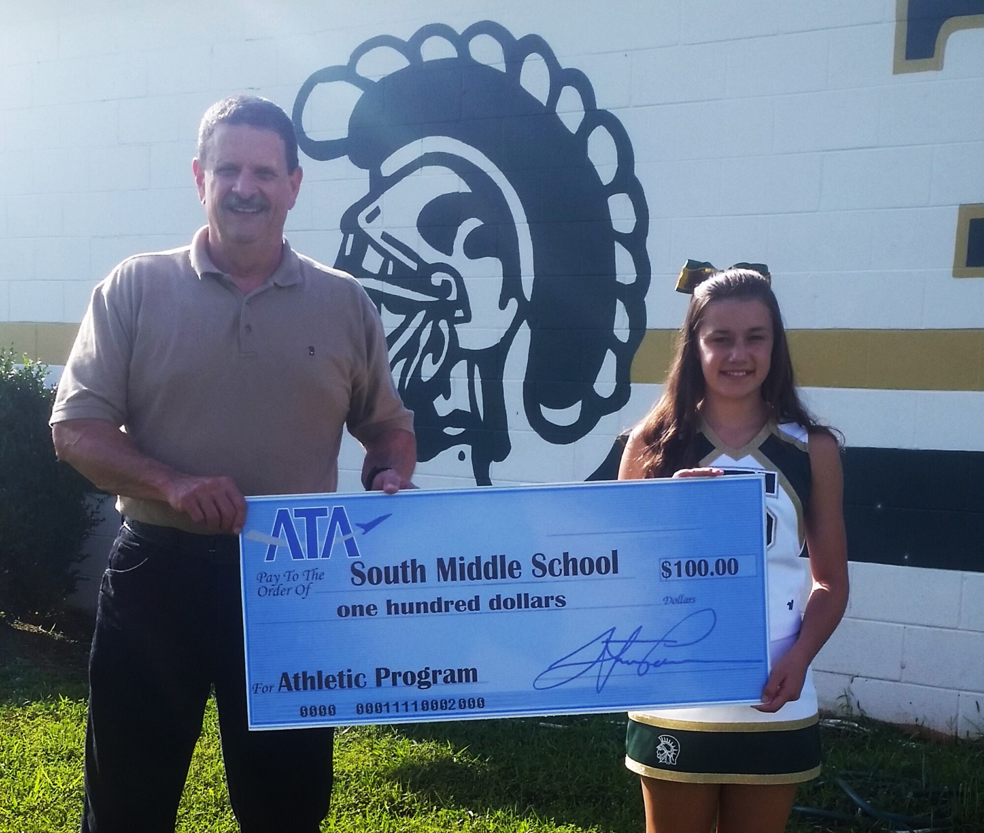 ATA Employee and Community Activities Committee member Ted Boswell presents a $100 ATA donation to Amelia Myers for the South Middle School Athletic Program. The E&CAC is responsible for making ATA donations to charitable organizations in the area surrounding Arnold Air Force Base. (Photo provided)