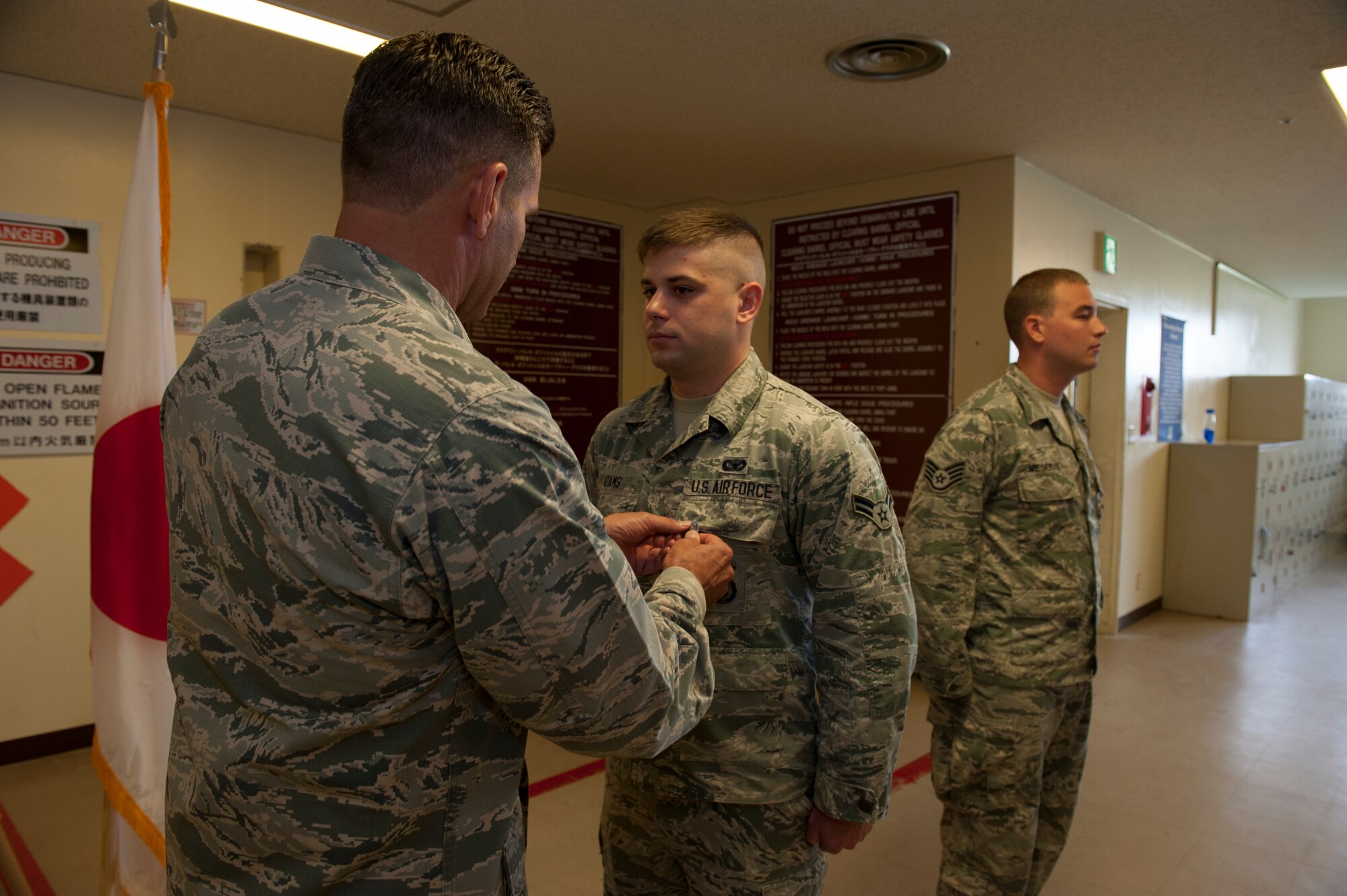 U.S. Air Force Brig. Gen. Barry Cornish, 18th Wing commander, pins the Air Force Achievement Medal on Airman 1st Class Ethan Adams, 18th Security Forces Squadron response force member, Nov. 4, 2015, at Kadena Air Base, Japan. The Air Force Achievement Medal is awarded for outstanding accomplishments and acts of courage. (U.S. Air Force photo by Airman 1st Class Lynette M. Rolen)