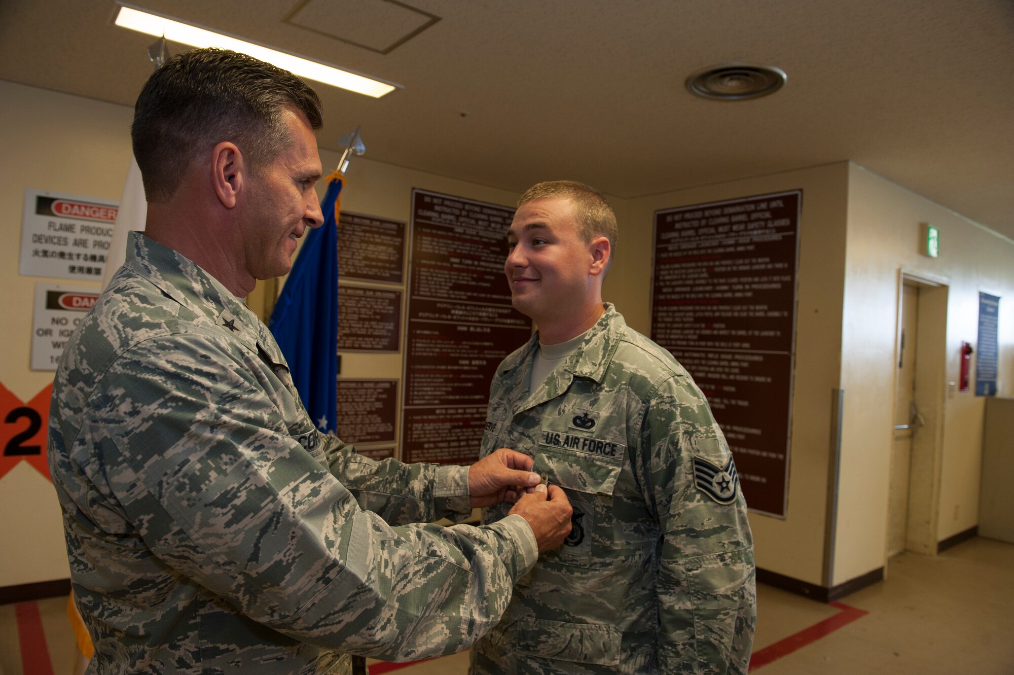 U.S. Air Force Brig. Gen. Barry Cornish, 18th Wing commander, pins the Air Force Achievement Medal on Staff Sgt. Matthew Meserve, 18th Security Forces Squadron response force leader, Nov. 4, 2015, at Kadena Air Base, Japan. Meserve received the award for saving an Airman’s life Sept. 5, 2015. (U.S. Air Force photo by Airman 1st Class Lynette M. Rolen)