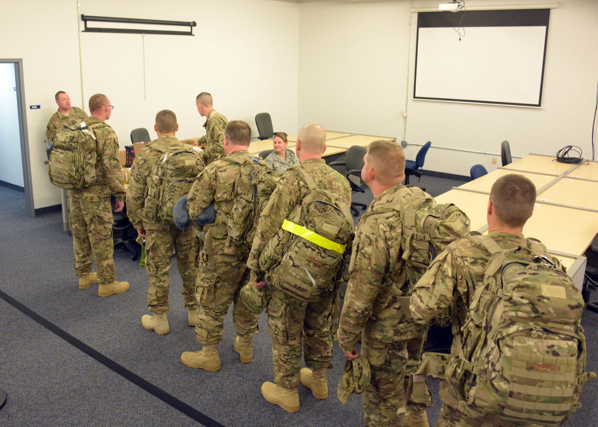219th Rapid Engineer Deployable Heavy Operational Repair Squadron Engineer (RED HORSE) Squadron members complete their final processing at Malmstrom Air Force Base, Mont., prior to deploying to the United States Central Command area of operations Oct. 3, 2015. The Montana Air National Guard personnel will conduct military engineering projects during the deployment. (U.S. Air National Guard photo by Senior Master Sgt. Eric Peterson/Released)