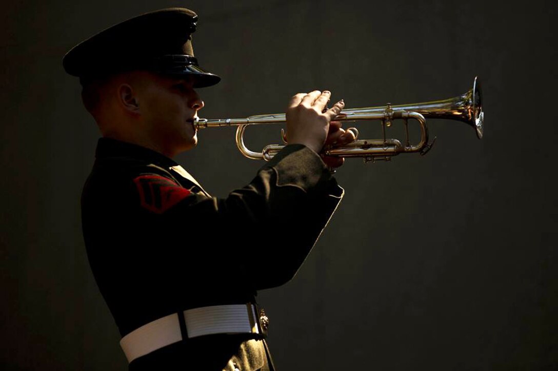 Marine Corps Cpl. Derek Detzler performs taps during the 32nd Beirut Memorial Observance Ceremony in Jacksonville, N.C., Oct. 23, 2015. The ceremony honored the memory of service members killed in the 1983 Marine Barracks bombing in Beirut, Lebanon. Detzler is a bugler with the 2nd Marine Division Band. U.S. Marine Corps photo by Cpl. Todd F. Michalek