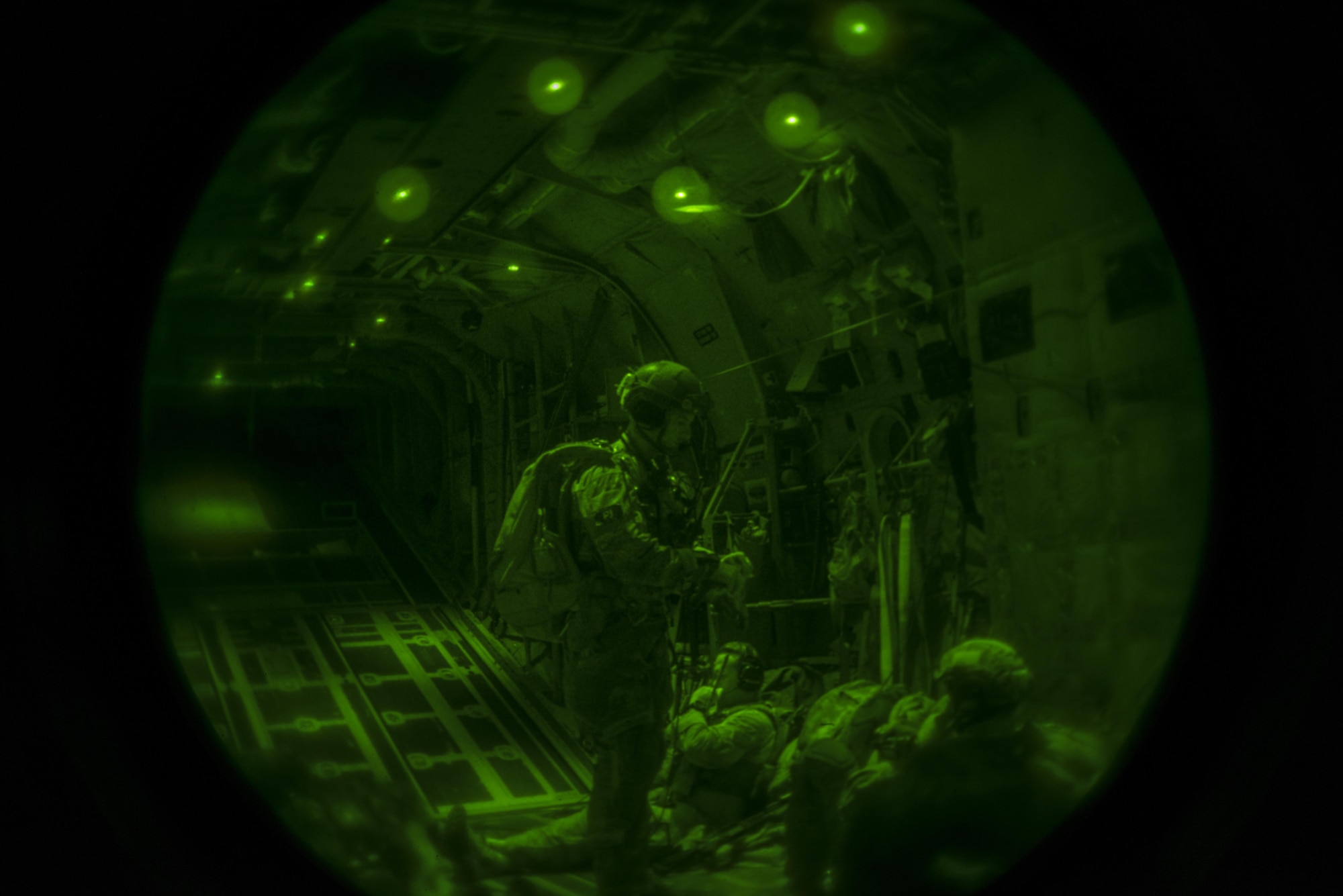 A U.S. air commando from the 352d Special Operations Wing checks his gear during transport via an MC-130J Commando II to a remote airstrip in Spain during TRIDENT JUNCTURE, Nov. 2, 2015. Upon arrival U.S. and Spanish air commandos participated in a rapid exfiltration training exercise under simulated fire. (U.S. Air Force photo by 1st Lt. Chris Sullivan/Released)