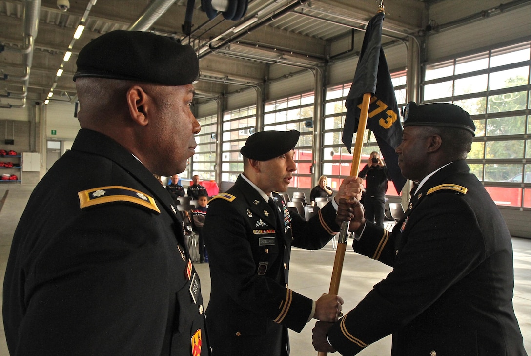 Col. Miguel Castellanos, center, commander of the 361st Civil Affairs Brigade, passes the 773rd Civil Support Team unit guidon to incoming commander Lt. Col. U.L. Armstrong, right, during the 773rd change of command ceremony Oct. 30, 2015 in Halle, Belgium. Outgoing 773rd commander, Lt. Col. Sandy Sadler, left, stands and watches. (Photo by Staff Sgt. Rick Scavetta, 7th Mission Support Command public affairs office)