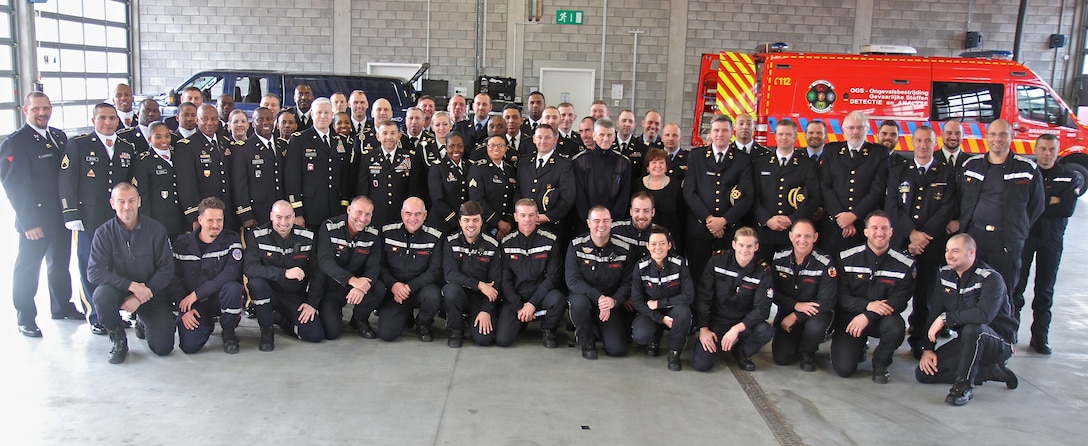 Soldiers and leaders from the 773rd Civil Support Team, 361st Civil Affairs Brigade and the 7th Mission Support Command pose for a photo with Belgian firefighters from Hulpverlenings Zone Vlaams-Brabant West after the 773rd change of command ceremony Oct. 30, 2015 in Halle, Belgium. (Photo by Staff Sgt. Rick Scavetta, 7th Mission Support Command public affairs office) 