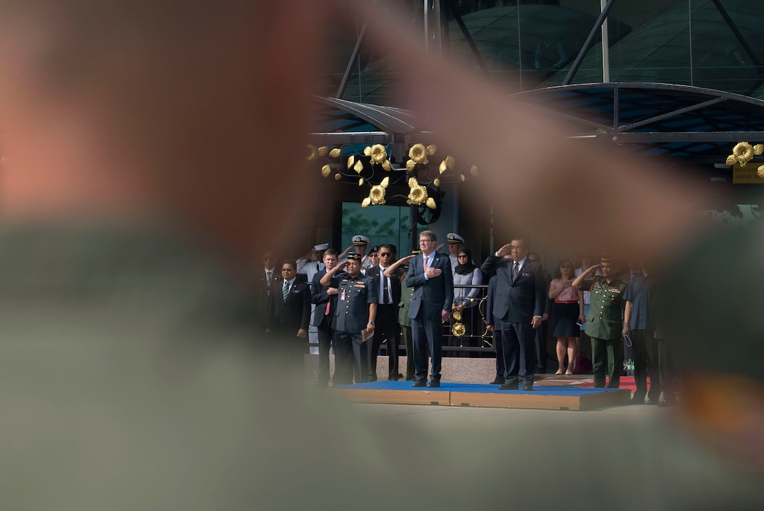 U.S. Defense Secretary Ash Carter renders honors as a joint carry team moves the transfer case of a recovered American World War II era aircrew onto a U.S. Air Force C-17 Globemaster during a repatriation ceremony in Subang, Malaysia, Nov. 5, 2015. DoD photo by U.S. Air Force Senior Master Sgt. Adrian Cadiz
