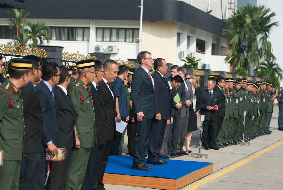 U.S. Defense Secretary Ash Carter stands with Malaysian Deputy Defense Minister Mohd Johari Baharum during a repatriation ceremony for the remains of a recovered American World War II era aircrew in Subang, Malaysia, Nov. 5, 2015. DoD photo by U.S. Air Force Senior Master Sgt. Adrian Cadiz