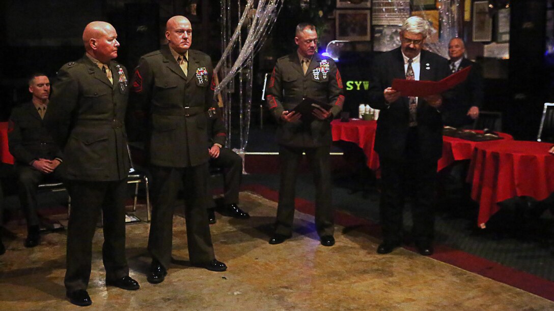 Gunnery Sgt. Mitchell S. McKenzie with the 2nd Marine Division listens to his award citation during the American Hero Awards Oct. 28, 2015 in Jacksonville, N.C. McKenzie saved the life of a Marine who expressed suicidal ideations while in a Wal-Mart parking lot.