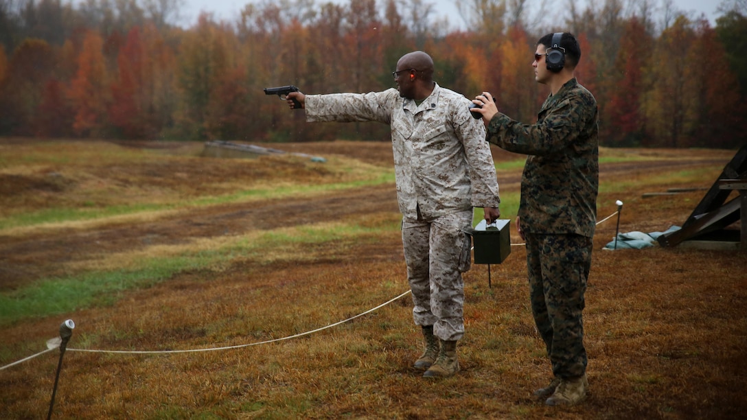 A Marine single-handedly shoots an M9 Beretta down range while carrying an ammo can in the other hand during the Quantico Shooting Team's 2015 Combat Shooting Match on Marine Corps Base Quantico, Oct. 26-30. Marines from all over the east coast attended the combat shooting match where they were required to plan, think and react quickly with several different weapons on each of the six stages. (U.S. Marine Corps photo by Cpl. Kathy Nunez)
