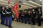 (Right to left) DLA Logistics Operations Director Navy Rear Adm. Vincent Griffith, Marine Corps Maj. Gen. Vincent Coglianese, and other Marine officers and senior non-commissioned officers stand for the presentation of the colors at the 240th Marine Corps Birthday celebration at the McNamara Headquarters Complex.