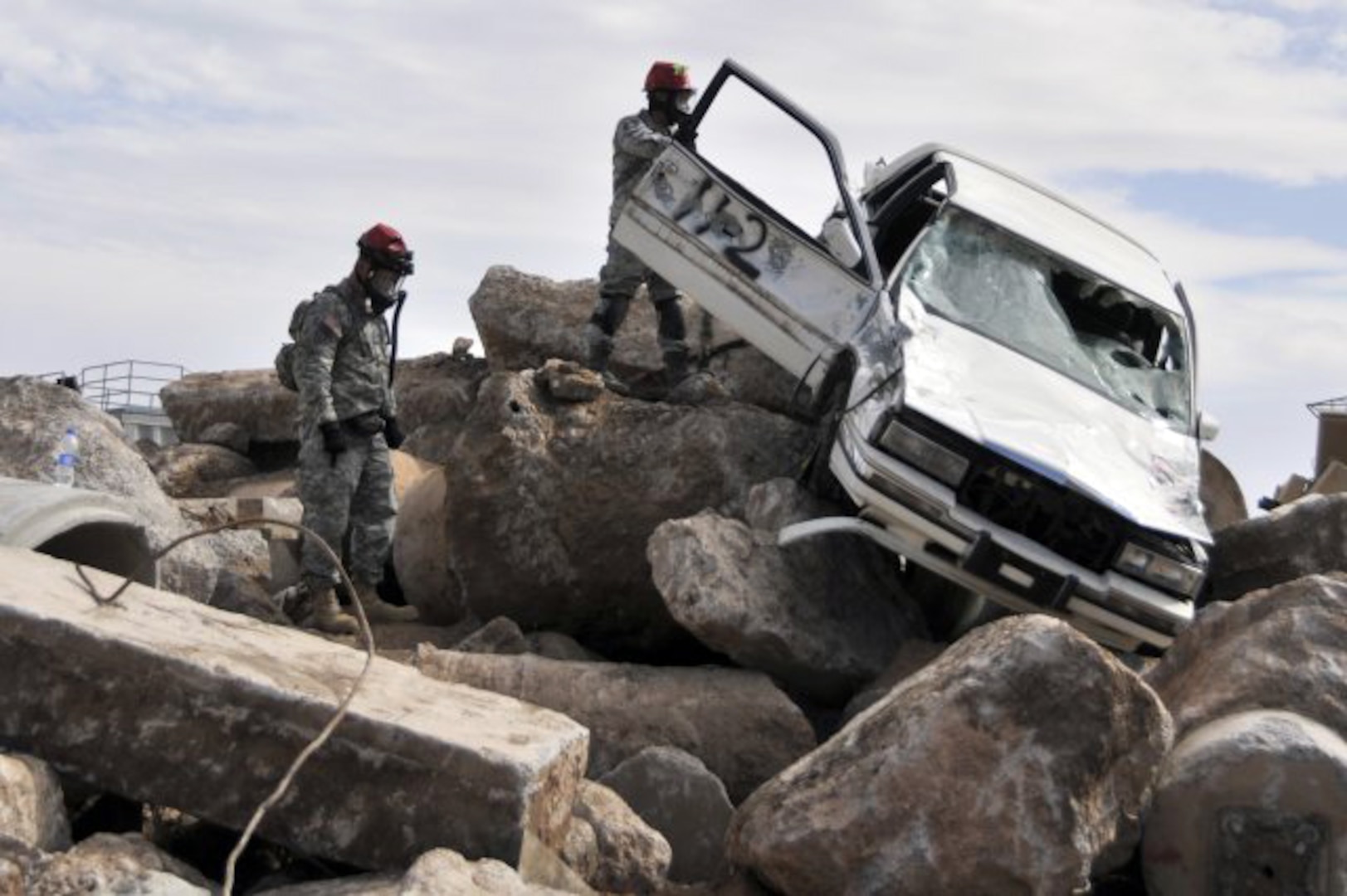 Combat engineers from the Ropes Platoon, 235th Engineer Company, 579th Engineer Battalion, 49th Military Police Brigade, California Army National Guard, secure a vehicle so it doesn't fall while victims are being rescued during the 2011 Arizona Vigilant Guard Exercise Nov. 4, 2011, in Phoenix. The Ropes platoon, which utilizes ropes and pulleys to open up confined spaces and rescue victims, is one of three platoons designated as part of the search and extraction team.