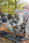 During a simulated exercise, Soldiers practice evacuating an injured Soldier during the first multi-component Warrior Leader Course at the Camp Beauregard Range Complex hosted by the Louisiana National Guard, Nov. 15, 2011. The Louisiana Guard provided training for National Guard, Reserve and active-duty Soldiers from Fort Polk, Nov. 4-18, 2011.