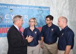 U.S. Rep. Joe Wilson, R-S.C., speaks with U.S. Army Maj. Barbara Mesaros, South Carolina National Guard director of intelligence, U.S. Army Maj. Robert Gresham, South Carolina Army National Guard cyber branch chief, and U.S. Army Col. David Coldren, South Carolina Army National Guard assistant chief of staff for information management, during the State Cyber Day event sponsored by the National Guard and Reserve Caucus of the U.S. House of Representatives at the Rayburn House Office Building Foyer, Washington, Oct. 22, 2015. 