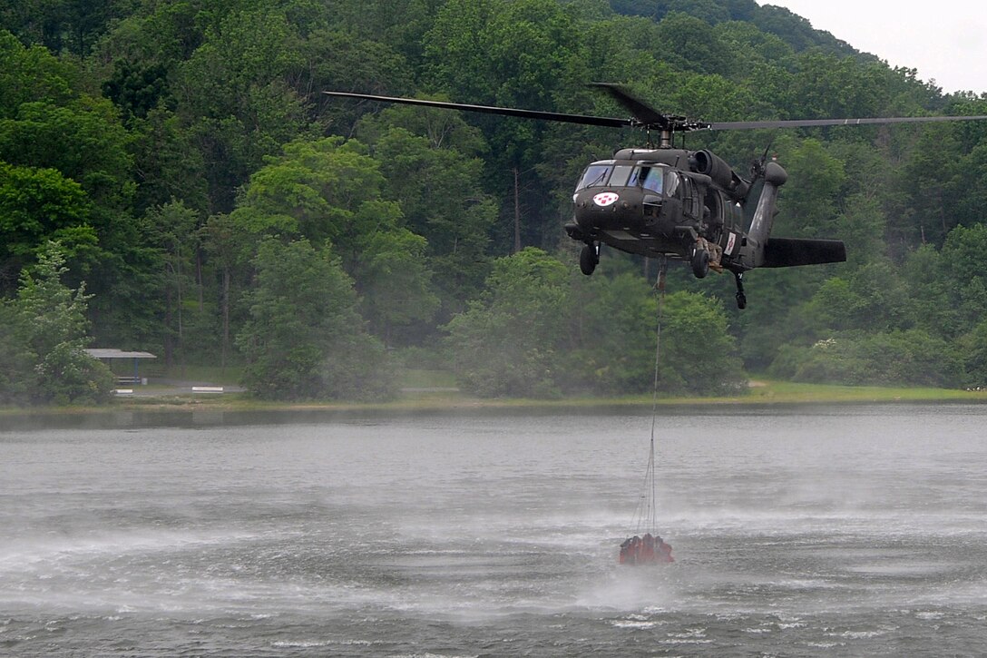 Shortly after returning to the Army in 2013, Pennsylvania Army National Guard Chief Warrant Officer 2 Sara Christensen participated in "Water Bucket" training at Fort Indiantown Gap, Pa. She is currently serving with Detachment 1, Charlie Company, 2-104th General Support Aviation Battalion, 28th Combat Aviation Brigade. Pennsylvania Army National Guard photo by Sgt. Neil Gussman
