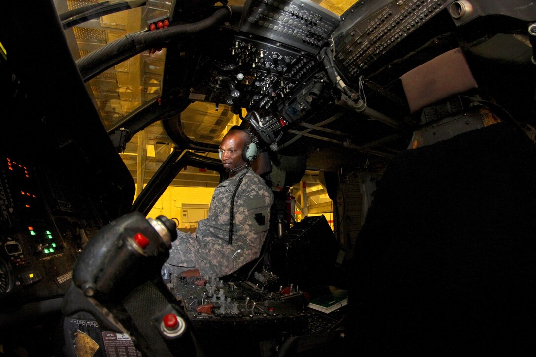 Army Sgt. 1st Class Gerald Cole looks over controls during a hydraulics test on a UH-60 Black Hawk helicopter on Joint Base McGuire-Dix-Lakehurst, N.J., Oct. 28, 2015. Cole is an avionics technician assigned to the New Jersey Army National Guard. New Jersey Air National Guard photo by Tech. Sgt. Matt Hecht