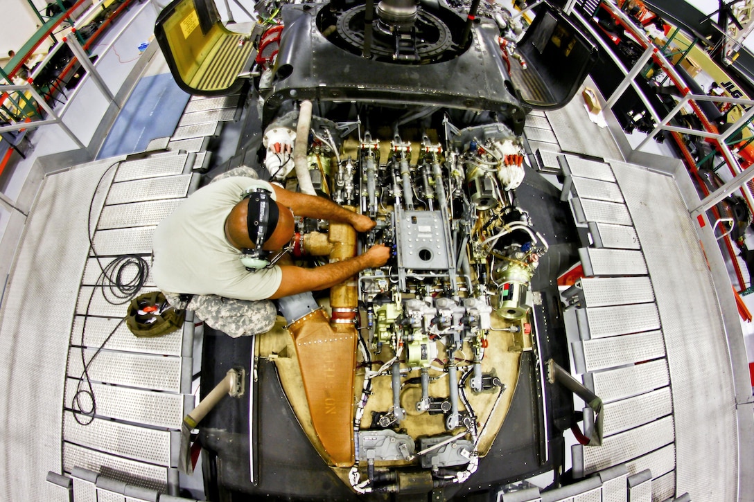 Army Sgt. Ronald Clark looks over parts during a hydraulics test on a UH-60 Black Hawk helicopter on Joint Base McGuire-Dix-Lakehurst, N.J., Oct. 28, 2015. Clark is an aircraft maintenance technician assigned to the New Jersey Army National Guard. New Jersey National Guard photo by Air Force Tech. Sgt. Matt Hecht