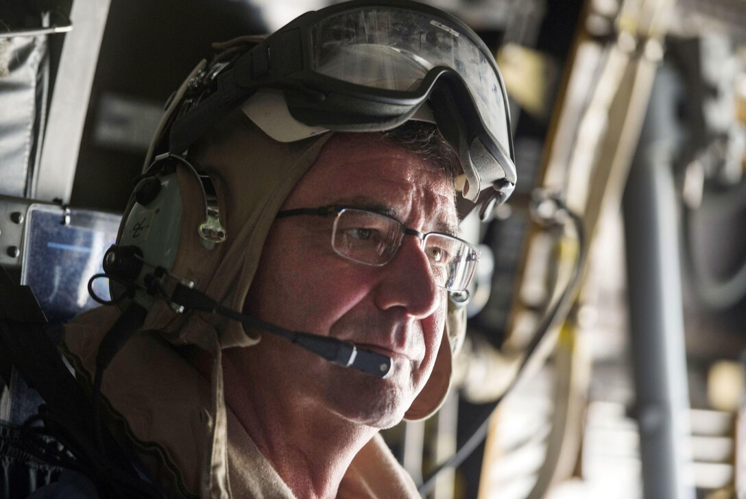 U.S Defense Secretary Ash Carter listens to radio traffic as he and Malaysian Defense Minister Hishammuddin Hussein fly on a V-22 Osprey to visit the USS Theodore Roosevelt, Nov. 5, 2015. DoD photo by Air Force Senior Master Sgt. Adrian Cadiz