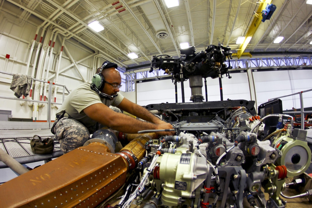 Army Sgt. Ronald Clark looks over parts during a hydraulics test on a UH-60 Black Hawk helicopter Joint Base McGuire-Dix-Lakehurst, N.J., Oct. 28, 2015. Clark is an aircraft maintenance technician assigned to the New Jersey Army National Guard. New Jersey Air National Guard photo by Tech. Sgt. Matt Hecht