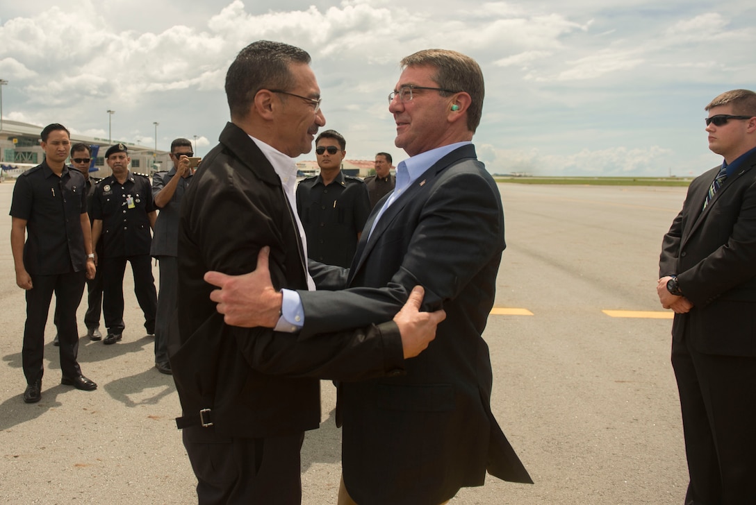 U.S Defense Secretary Ash Carter, right, greets Malaysian Defense Minister Hishammuddin Hussein as they both arrive Sabah, Malaysia, Nov. 5, 2015, to fly to visit the USS Theodore Roosevelt. DoD photo by Air Force Senior Master Sgt. Adrian Cadiz