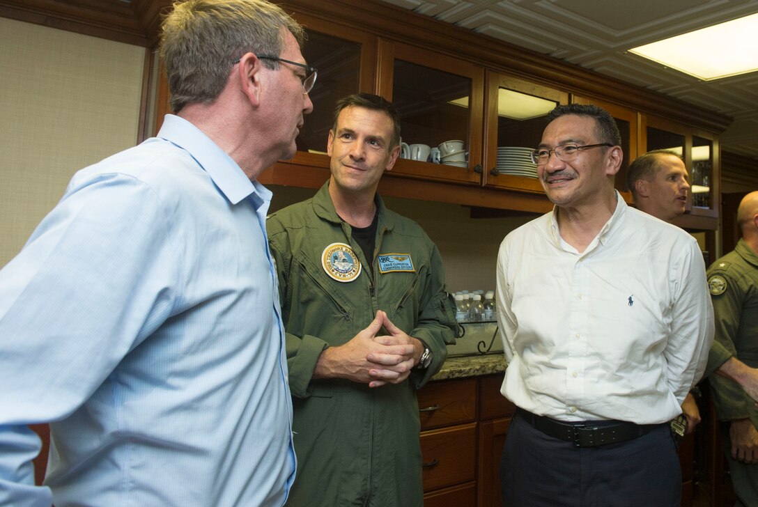 U.S Defense Secretary Ash Carter, left, and Malaysian Defense Minister Hishammuddin Hussein speak with U.S. Navy Capt. Craig Clapperton, the commanding officer of the USS Theodore Roosevelt, as they visit the aircraft carrier, Nov. 5, 2015. DoD photo by Air Force Senior Master Sgt. Adrian Cadiz