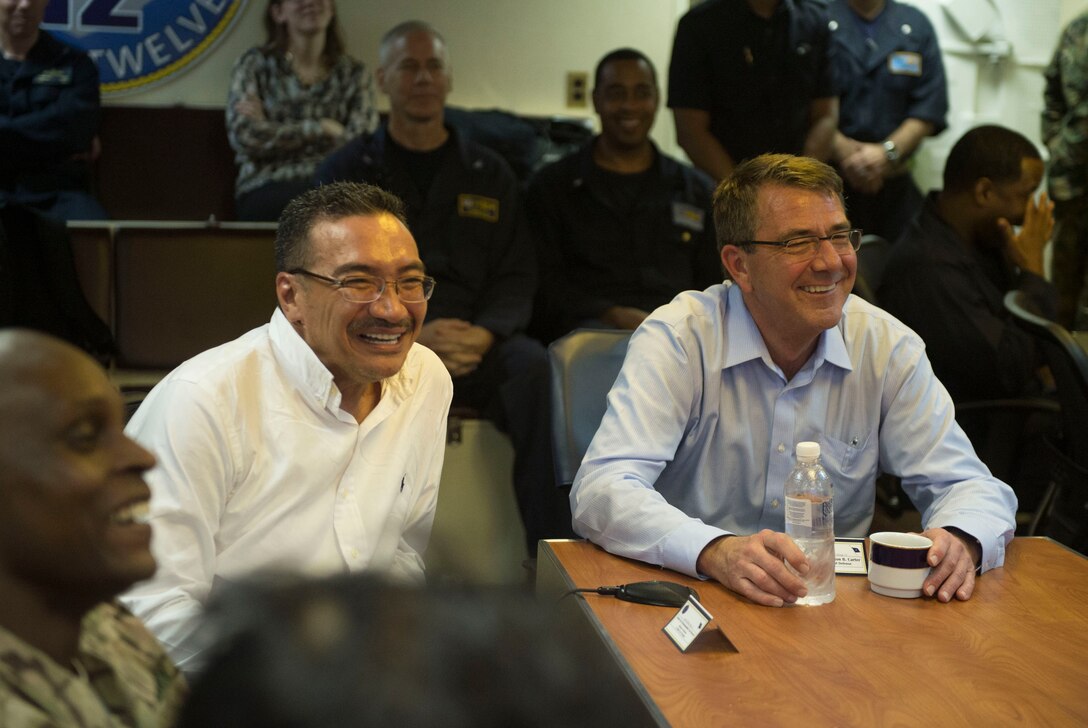 U.S Defense Secretary Ash Carter, right, and Malaysian Defense Minister Hishammuddin Hussein share a light moment during a briefing on the capabilities of the USS Theodore Roosevelt as they visit the carrier. Nov. 5, 2015. DoD photo by Air Force Senior Master Sgt. Adrian Cadiz