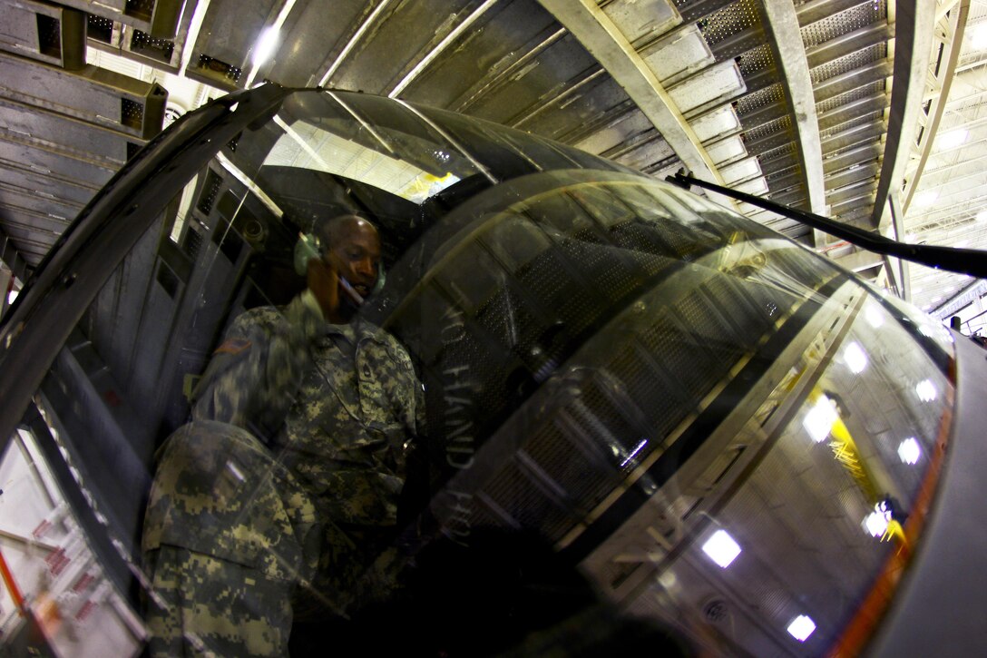 Army Sgt. 1st Class Gerald Cole looks over controls during a hydraulics test on a UH-60 Black Hawk helicopter on Joint Base McGuire-Dix-Lakehurst, N.J., Oct. 28, 2015. Cole is an avionics technician assigned to the New Jersey Army National Guard. New Jersey Air National Guard photo by Tech. Sgt. Matt Hecht