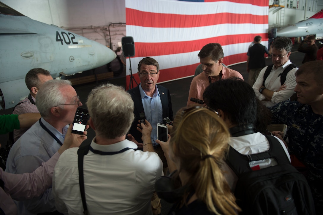 U.S. Defense Secretary Ash Carter answers questions from reporters during a visit aboard the USS Theodore Roosevelt at sea, Nov. 5, 2015. Carter toured the aircraft carrier with Malaysian Defense Minister Hishammuddin Hussein, not shown, during his eight-day visit to the Asia-Pacific region to help advance the U.S. military rebalance to the region. DoD photo by Air Force Senior Master Sgt. Adrian Cadiz
