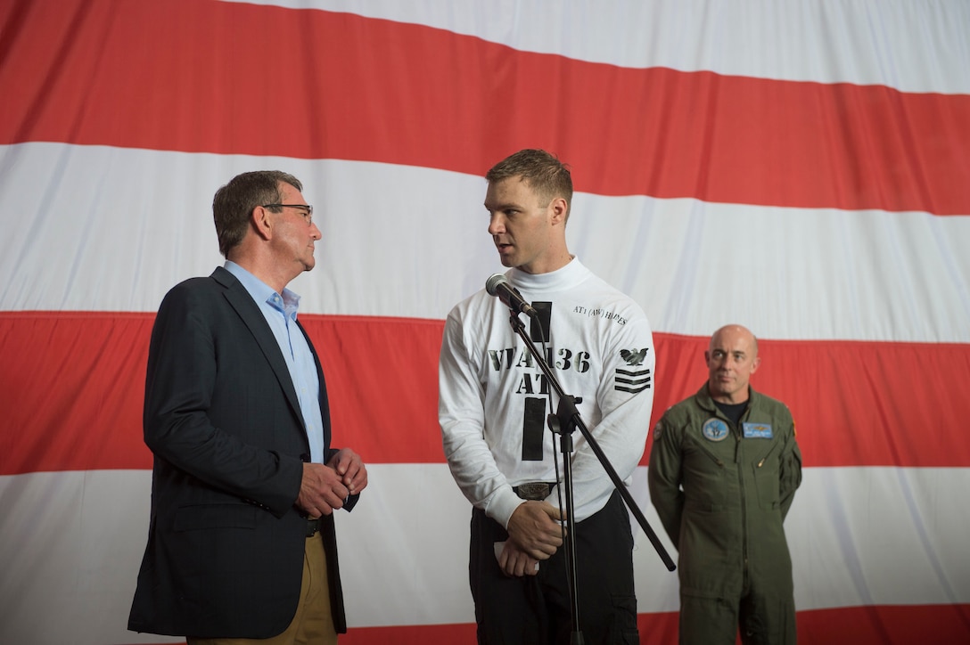 U.S. Defense Secretary Ash Carter, left, speaks with a U.S. service member on the USS Theodore Roosevelt as he and Malaysian Defense Minister Hishammuddin Hussein visit the aircraft carrier Nov. 5, 2015. DoD photo by Air Force Senior Master Sgt. Adrian Cadiz