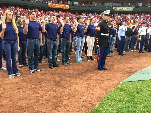 Marine Corps Poolees take part in a sware0in ceremony at Busch Stadium, St. Louis September 27. The swear-in was part of a military appreciation day. 