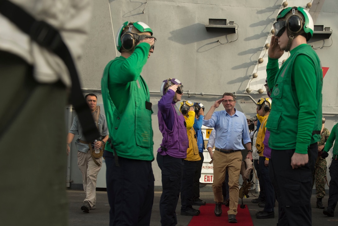 U.S. Navy sailors salute U.S Defense Secretary Ash Carter as he and Malaysian Defense Minister Hishammuddin Hussein depart the USS Theodore Roosevelt after visiting the aircraft carrier in the South China Sea, Nov. 5, 2015. DoD photo by U.S. Air Force Senior Master Sgt. Adrian Cadiz
