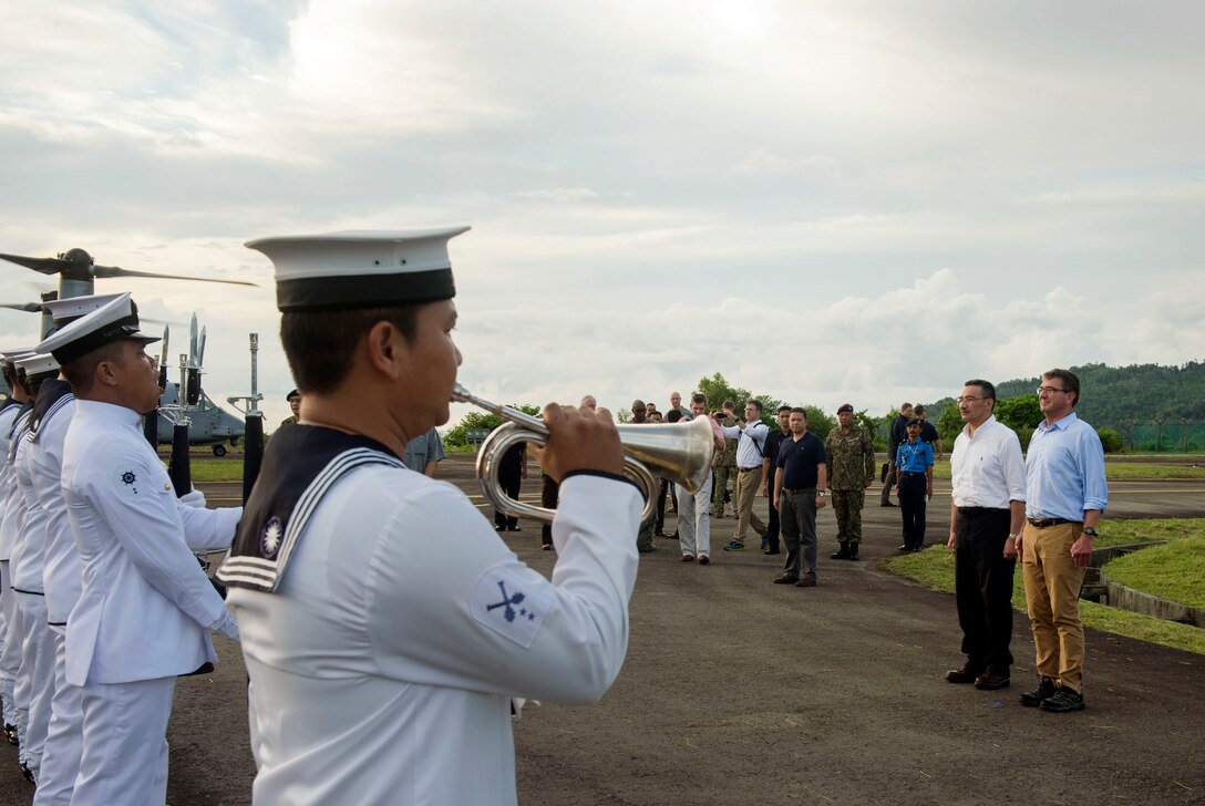 U.S. Defense Secretary Ash Carter and Malaysian Defense Minister Hishammuddin Hussein listen to a Malaysian navy honor guard as they arrive at Sepanggar Naval Base, Malaysia, Nov. 5, 2015. DoD photo by Air Force Senior Master Sgt. Adrian Cadiz