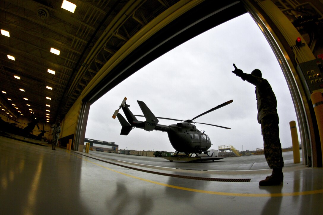 A soldier marshals a UH-72 Lakota helicopter into the Army Aviation Support Facility on Joint Base McGuire-Dix-Lakehurst, N.J., Oct. 28, 2015. New Jersey Air National Guard photo by Tech. Sgt. Matt Hecht