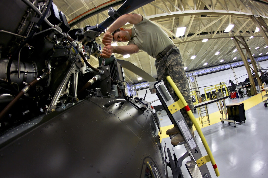 Army Sgt. Andrew Koniecko works on a UH-72 Lakota helicopter on
Joint Base McGuire-Dix-Lakehurst, N.J., Oct. 28, 2015. Koniecko is an aircraft maintenance technician assigned to the New Jersey Army National Guard. New Jersey Air National Guard photo by Tech. Sgt. Matt Hecht