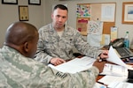 Members of the 102nd Security Forces Squadron receive feedback by an Air Combat Command inspector during the units first Compliance Inspection since its re-designation as an Intelligence Wing in 2008.