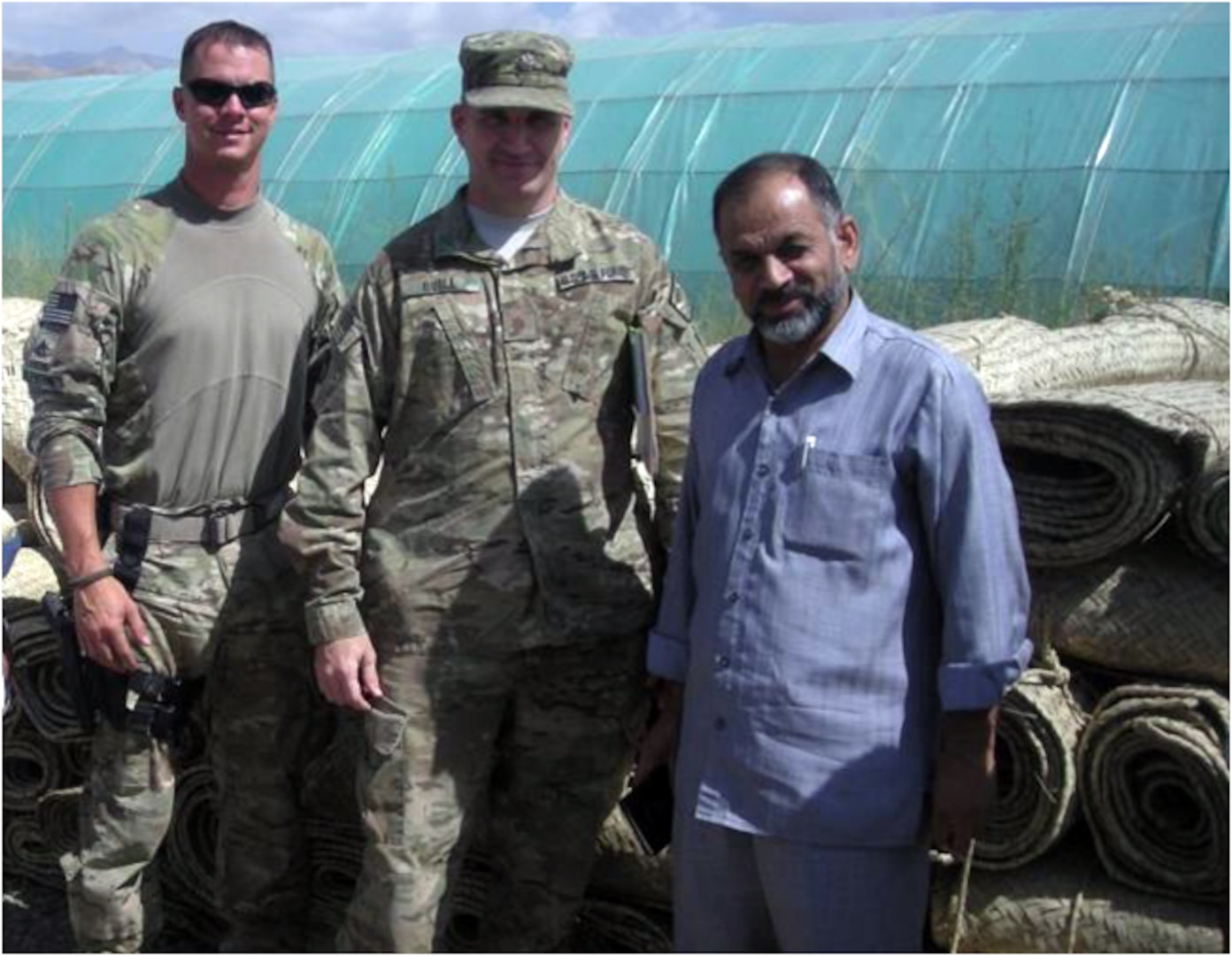 Army Staff Sgt. Jeffrey Valentine, Army Maj. Bernie Quill and members of the Kentucky Agribusiness Development Team 3 work with one of the local Afghan businessmen, Abdul Farzam, on developing their agricultural businesses during their deployment to Afghanistan.