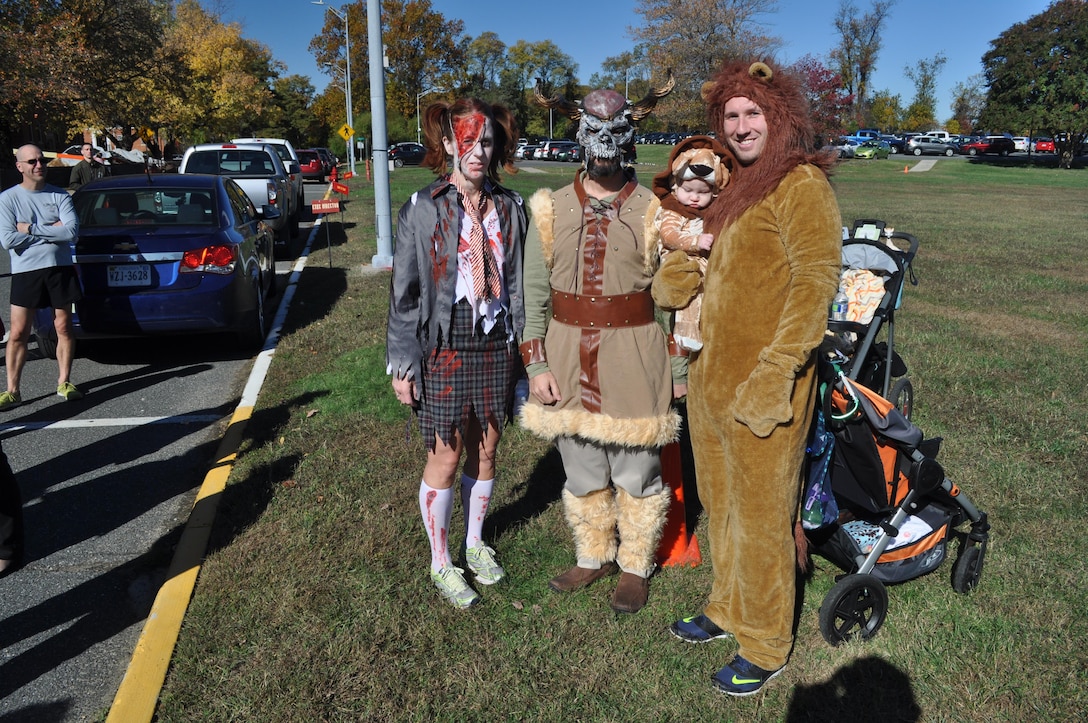 Systems Command 5K costume contest winners, from left to right: Ruth Cisneros, Rocco Blais, and Ryan (held by his father, Karl Harris).