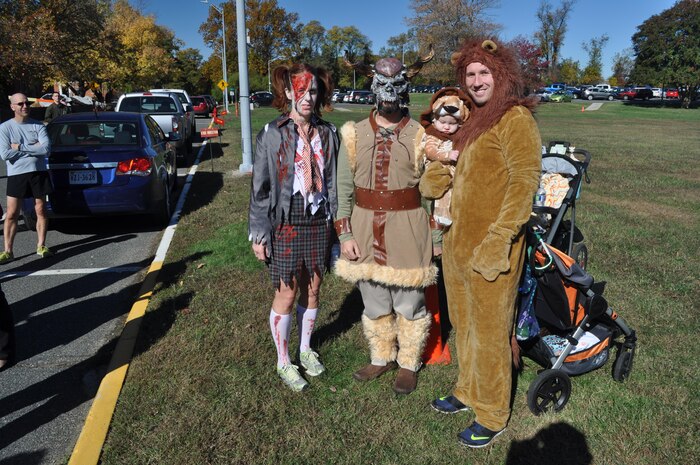 Systems Command 5K costume contest winners, from left to right: Ruth Cisneros, Rocco Blais, and Ryan (held by his father, Karl Harris).