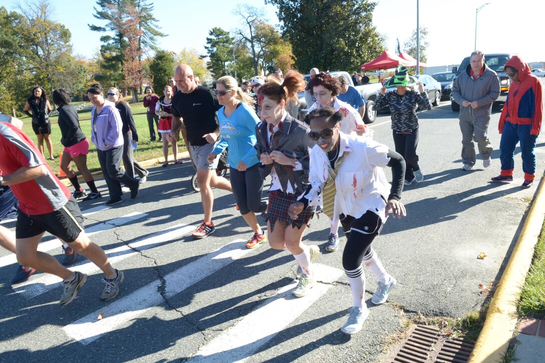 Runners and zombies start the zombie 5k run sponsored by Marine Corps Systems Command aboard Marine Corps Base Quantico Oct. 30.