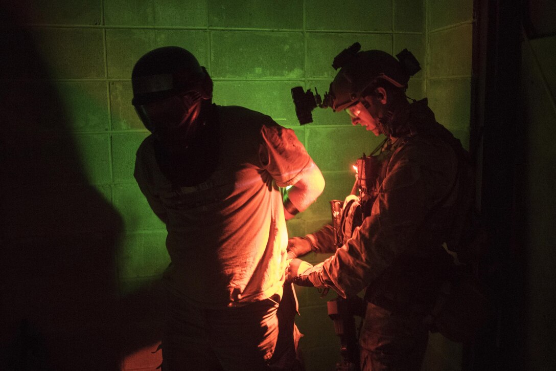 A special operations airman helps identify, treat and process a simulated rescued hostage during a noncombatant evacuation exercise as part of Southern Strike 16 on Meridian Naval Air Station, Miss., Nov. 3, 2015. During the exercise, rescue personnel arrived by helicopter to a mock embassy, engaged simulated enemy forces and rescued role players acting as hostages. New York National Guard photo by Air Force Staff Sgt. Christopher S. Muncy