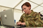 Staff Sgt. Nicole Brittain, the noncommissioned officer in charge of the Pennsylvania Army National Guard's 213th Regional Support Group's personnel division, works on a personnel report at Exercise Trident Juncture 15, near Zaragoza, Spain, Nov. 3, 2015.