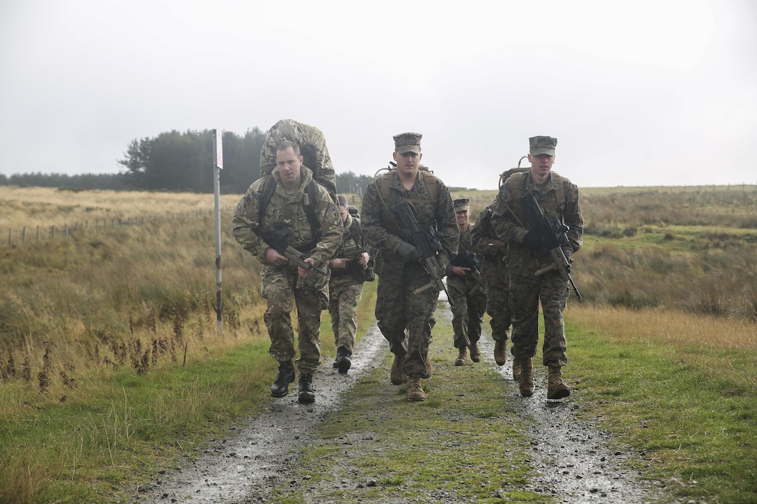 U.S. Marine Lance Cpl. Jason Shillingburg, center, and Lance Cpl. Mason Foth, right, execute a three-mile conditioning hike with other U.S. Marines and British soldiers during Exercise Phoenix Odyssey II near Edinburgh, U.K., Oct. 30, 2015. Shillingburg and Foth are both intelligence specialists with 2nd Intelligence Battalion. The Marines and their British counterparts are currently working to enhance joint intelligence operations and military skills for potential real-world contingencies. (U.S. Marine Corps photo by Cpl. Lucas Hopkins/Released)