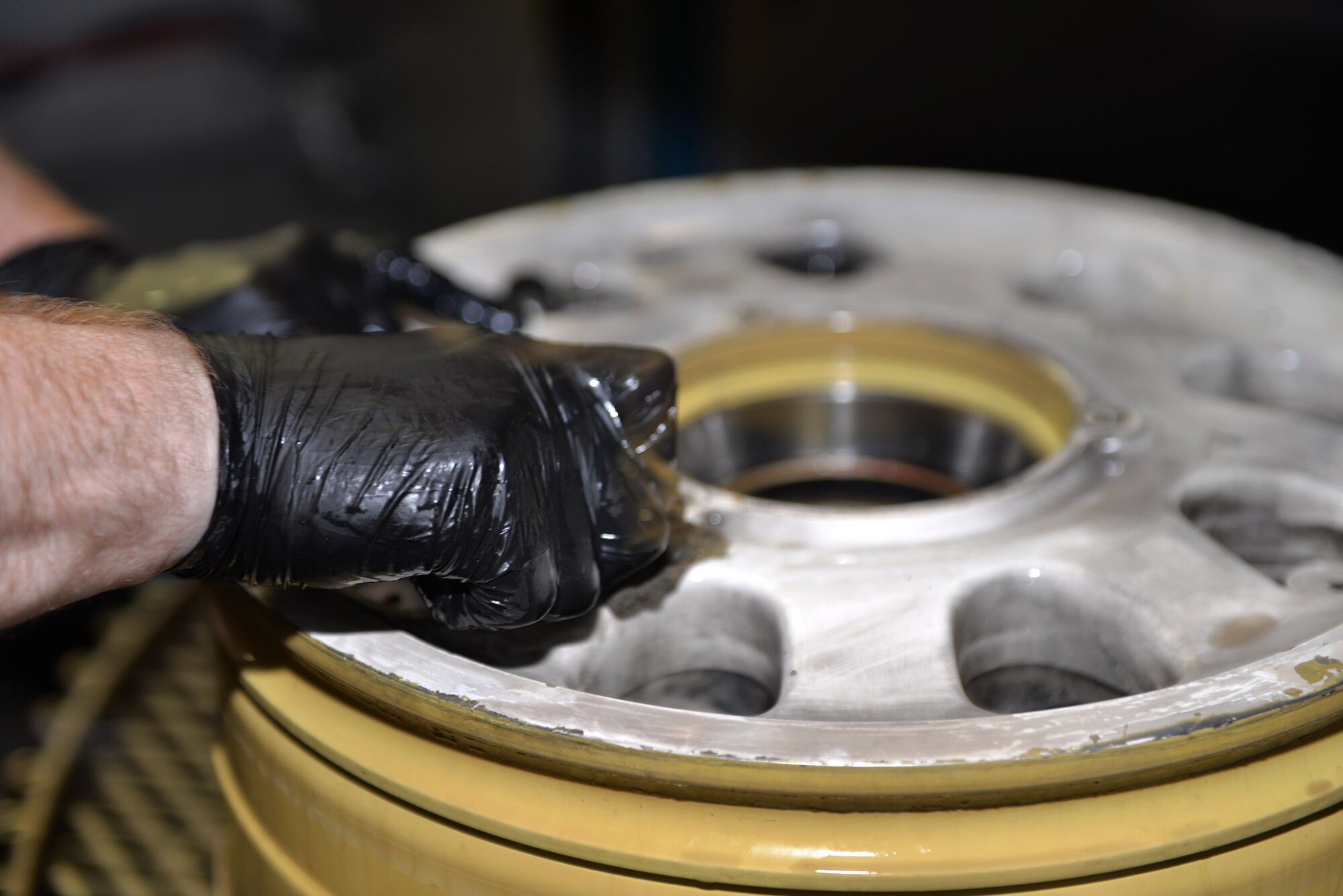 Senior Airmen Kenneth Chandler, 33rd Maintenance Squadron crew chief, cleans the wheel of an F-35A Lightning II at Eglin Air Force Base, Fla., Nov. 4, 2015. The wheel and tire back shop cleans the wheels to prevent corrosion when they are brought in to be serviced. (U.S. Air Force Photo/Senior Airman Andrea Posey)