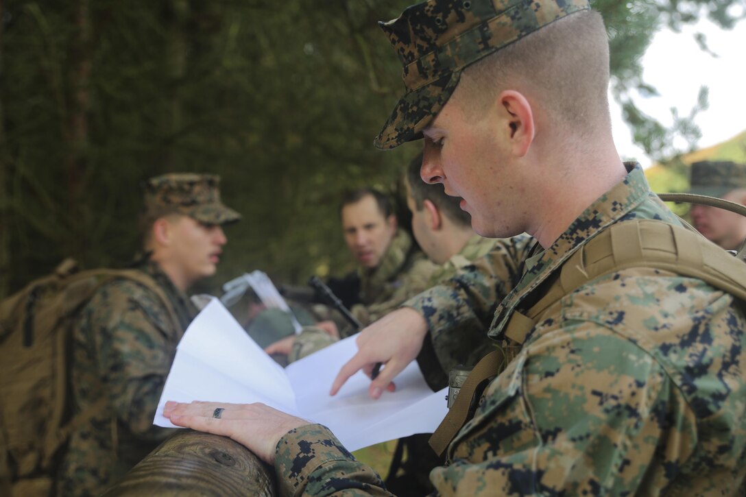 U.S. Marine Sgt. Kyle Bailey, an intelligence specialist with 2nd Intelligence Battalion, checks coordinates while searching for a checkpoint during Exercise Phoenix Odyssey II near Edinburgh, U.K., Oct. 30, 2015. The Marines are partnering with British soldiers to enhance joint intelligence operations, and worked to build military skills such as land navigation and combat marksmanship. (U.S. Marine Corps photo by Cpl. Lucas Hopkins/Released)