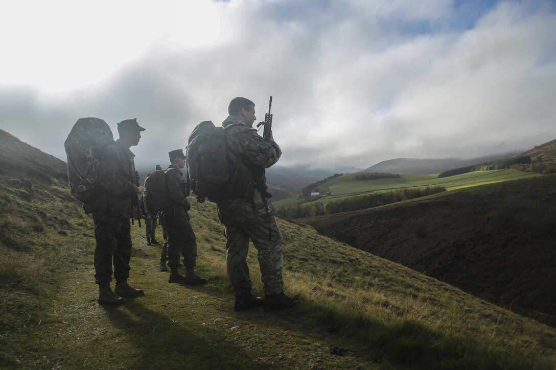 U.S. Marines with 2nd Intelligence Battalion and British soldiers search for a checkpoint during Exercise Phoenix Odyssey II near Edinburgh, U.K., Oct. 30, 2015. The service members executed a three-mile conditioning hike and shooting competition as part of the exercise, which is designed to enhance joint intelligence operations. (U.S. Marines Corps photo by Cpl. Lucas Hopkins/Released)