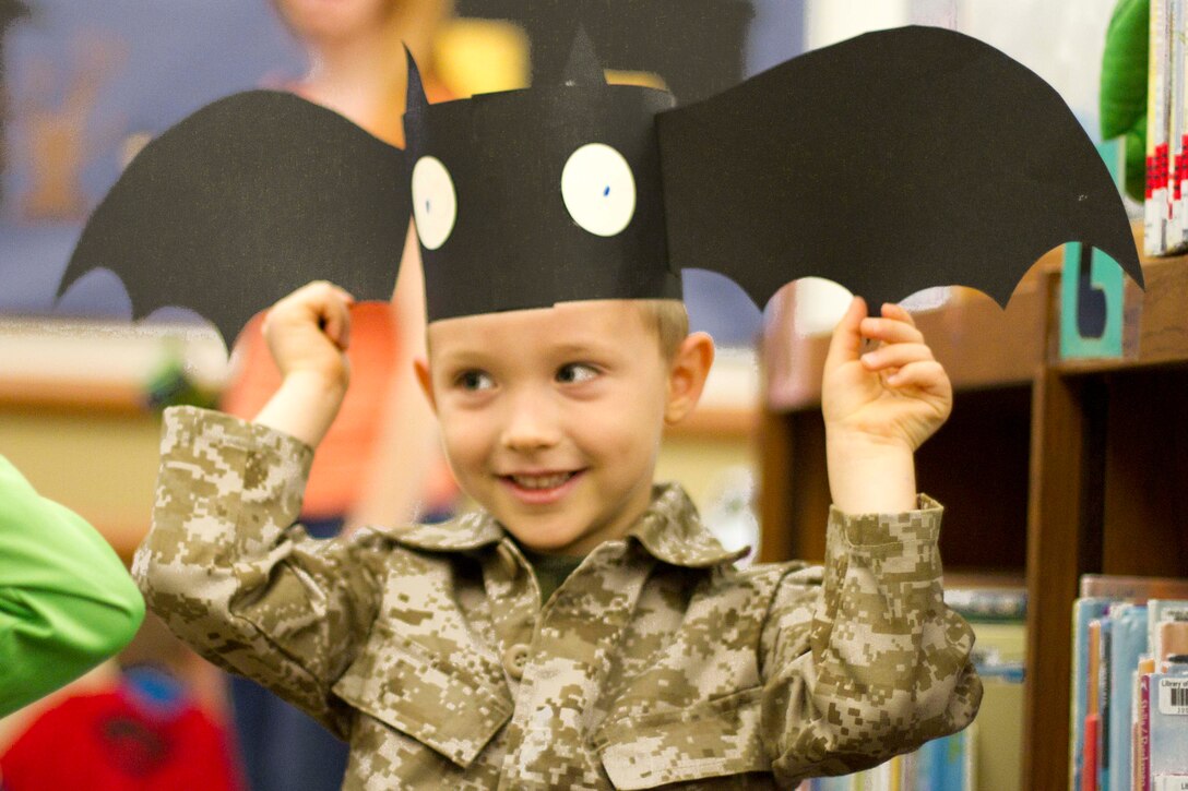 Five-year-old military child, Kade, completes Halloween craft during the Halloween Bash Oct. 30 at the Gray Research Center. Children participated in an arts and craft activity and interactive music.