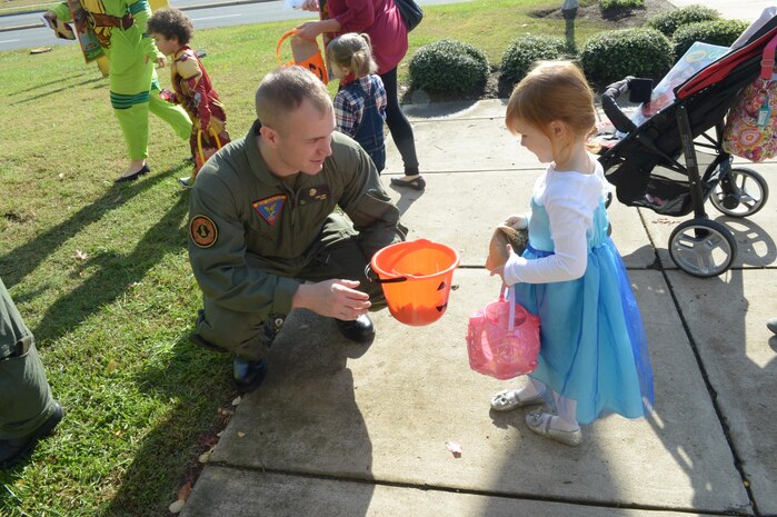 Sgt. Andrew Kirkland, Aircraft, Rescue and Firefighting at Quantico Marine Corps Air Facility, hands out candy at the MCCS trick or treating at Little Hall aboard Marine Corps Base Quantico on Oct. 29.