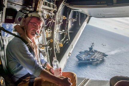 SUBBANG, Malaysia (Nov. 5, 2015) - The USS Theodore Roosevelt can be seen in the back ground as Secretary of Defense Ash Carter flies in a V-22 Osprey after visiting the aircraft carrier with Malaysian Minister of Defense Hishammuddin Hussein.  
