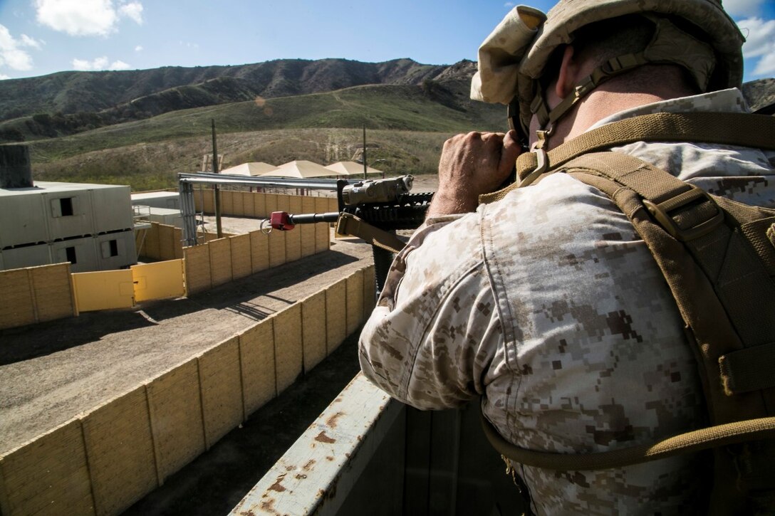 U.S. Marines with Battalion Landing Team 2/1, 13th Marine Expeditionary Unit (MEU), surround a building suspected of holding simulated enemy combatants as the MEU conducts amphibious assault training during Composite Training Unit Exercise (COMPTUEX) at Marine Corps Base Camp Pendleton, Calif., Nov. 3, 2015. COMPTUEX provides the MEU ARG the opportunity to integrate naval training while also allowing focused, mission-specific training and evaluation for the Marines and their Navy counterparts. (U.S. Marine Corps photo by Cpl. Briauna Birl/RELEASED)