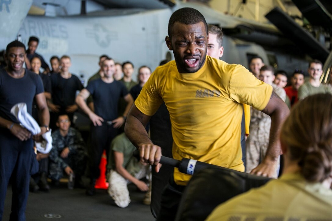 INDIAN OCEAN (Oct. 31, 2015) A U.S. Sailor with the Essex Amphibious Ready Group executes baton strikes after being sprayed with oleoresin capsicum during a non-lethal weapons course aboard the amphibious assault ship USS Essex (LHD 2). U.S. Marines and Sailors were sprayed across the face with OC spray and went through a series of exercises as their final event of the course. (U.S. Marine Corps photo by Sgt. Anna Albrecht/ Released)