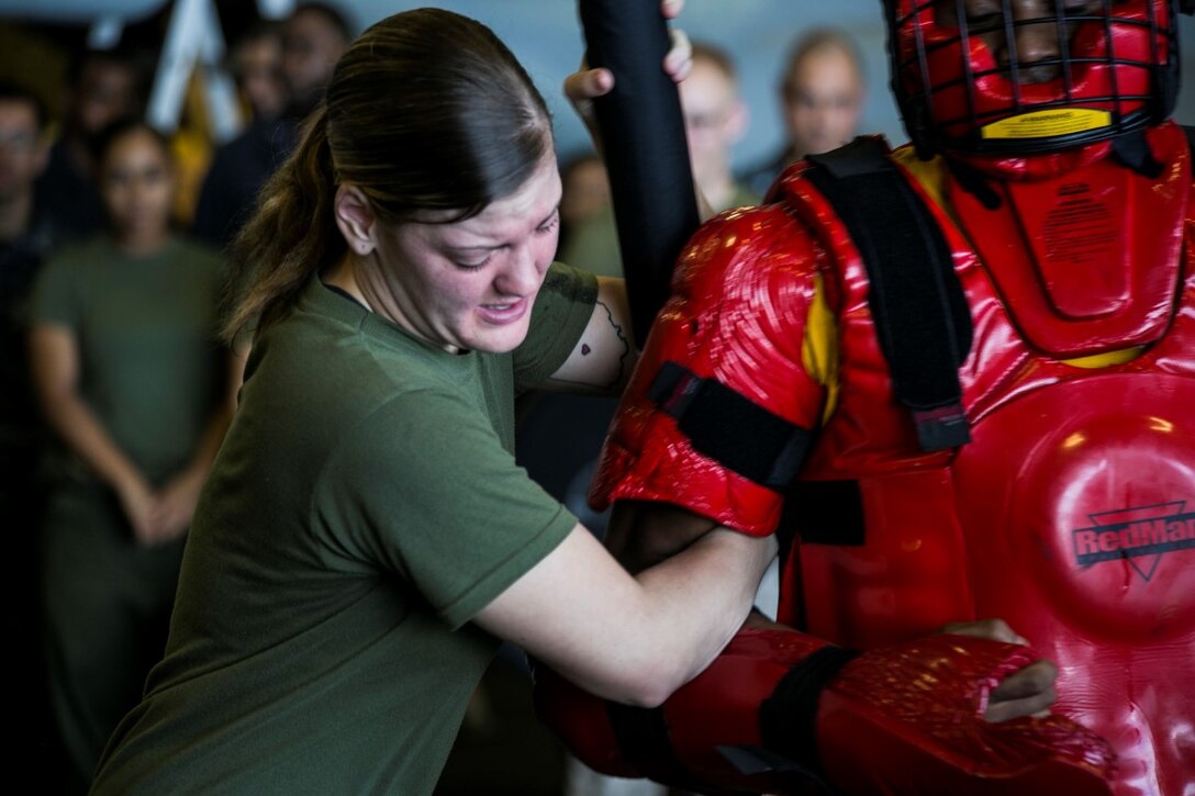 INDIAN OCEAN (Oct. 31, 2015) U.S. Marine Lance Cpl. Breeann Rogers executes a take-down technique after being  sprayed with oleoresin capsicum during a non-lethal weapons course aboard the amphibious assault ship USS Essex (LHD 2). Rogers is a motor transportation operator with Combat Logistics Battalion 15, 15th Marine Expeditionary Unit, and is a member of the combat cargo platoon. U.S. Marines and Sailors were sprayed across the face with OC spray and went through a series of exercises as their final event of the course. (U.S. Marine Corps photo by Sgt. Anna Albrecht/ Released)