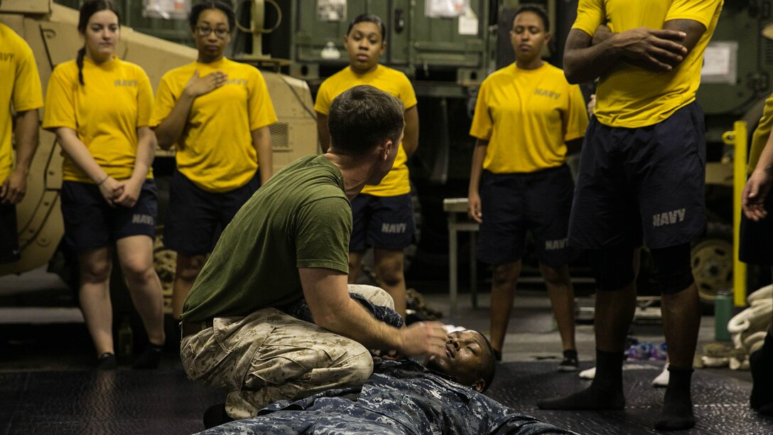 U.S. Marine Sgt. Justin Leduc demonstrates a take-down technique on the USS Essex at the Golf of Oman, Oct. 30, 2015 during a non-lethal force course. Leduc is the non-commissioned-officer-in-charge for the Law Enforcement Detachment, Combat Logistics Battalion 15, 15th Marine Expeditionary Unit. The course includes different techniques Navy and Marine watch-standers can utilize on aggressors before escalating to lethal force. 